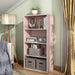 Left facing durable modern four-shelf light pink storage bookcase in a room with accessories