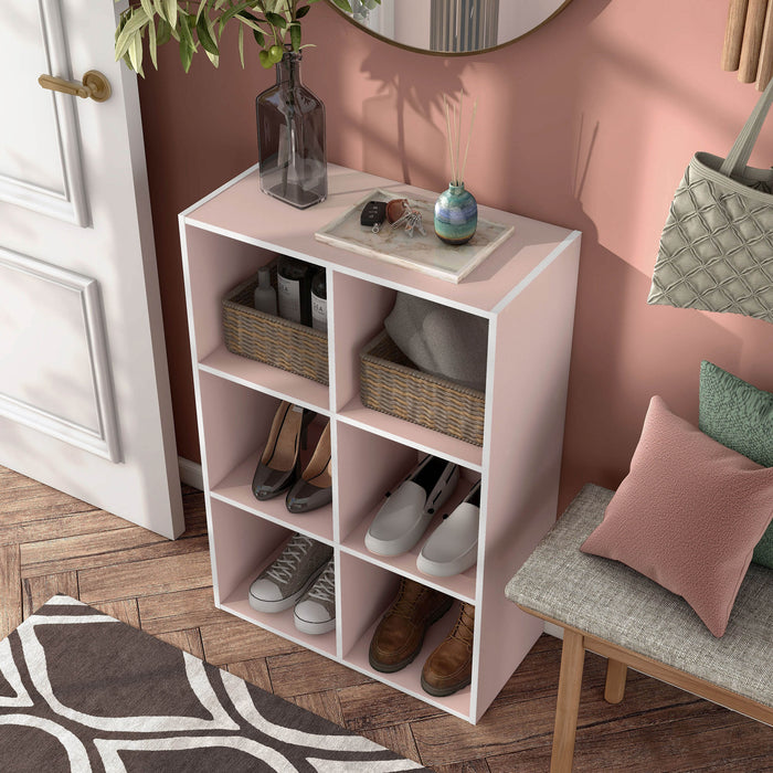 Left facing high-camera view of a durable modern six-cubby light pink storage bookcase in a room with accessories