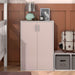 Front facing durable modern two-door light pink storage cabinet with silver handles as part of a larger modular configuration in a room with accessories