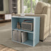 Left facing durable modern two-shelf light blue storage bookcase in a room with accessories