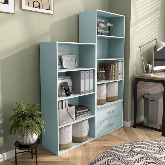 Right facing durable modern four-shelf light blue storage bookcase as part of a larger modular configuration in a room with accessories