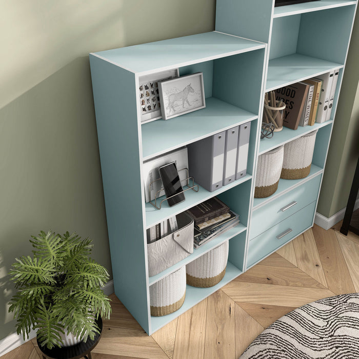 Right facing high-camera view of a durable modern four-shelf light blue storage bookcase as part of a larger modular configuration in a room with accessories