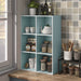 Left facing durable modern six-cubby light blue storage bookcase in a room with accessories