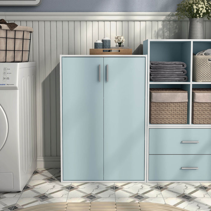 Front facing durable modern two-door light blue storage cabinet with silver handles as part of a larger modular configuration in a room with accessories