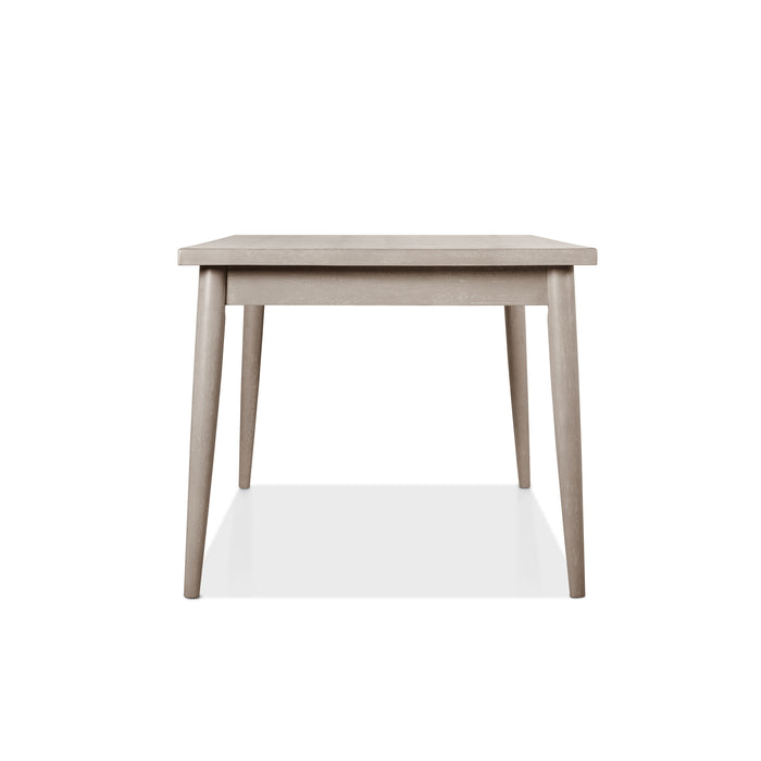 Front facing side view of a durable modern engineered wood rectangular dining table with a natural finish on a white background