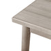 Left facing close up view of the corner of a durable modern engineered wood rectangular dining table with a natural finish on a white background