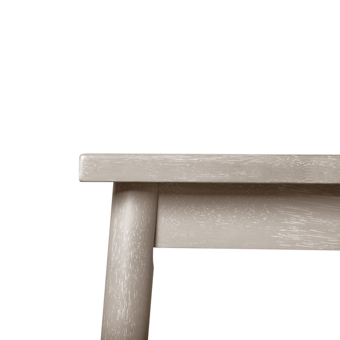 Front facing close up view of the corner and upper leg of a durable modern engineered wood rectangular dining table with a natural finish on a white background