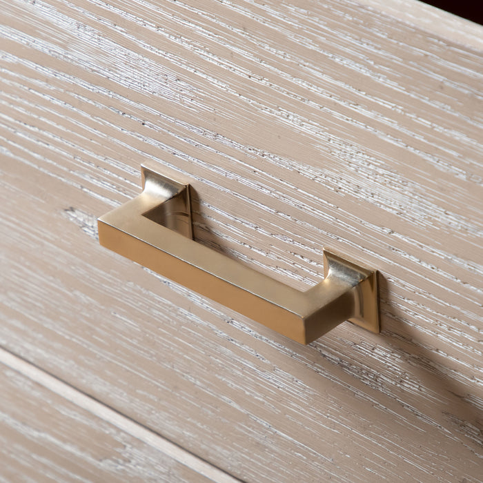 Left facing close up of the bar drawer pull on a transitional light oak seven-drawer dresser and mirror with a metal base