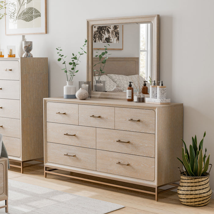 Left facing transitional light oak seven-drawer dresser and mirror with a metal base in a room with accessories