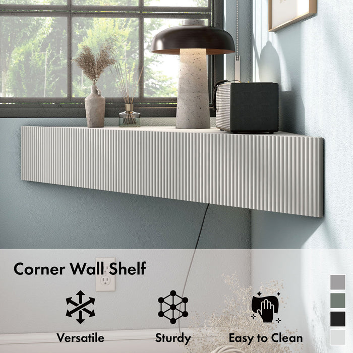 Informational image of a transitional wall-mount media console with a wavy front design showing its corner design, in a room with accessories