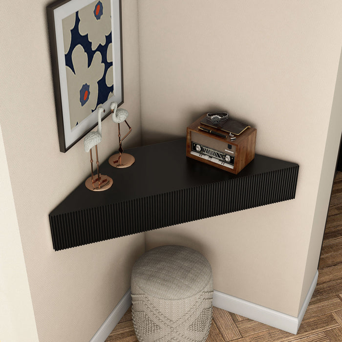 Right facing high-camera view of a transitional black wall-mount media console with a wavy front design in a room with accessories