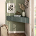 Left facing transitional sage green wall-mount media console with a wavy front design in a room with accessories