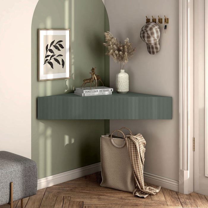 Front facing transitional sage green wall-mount media console with a wavy front design in a room with accessories