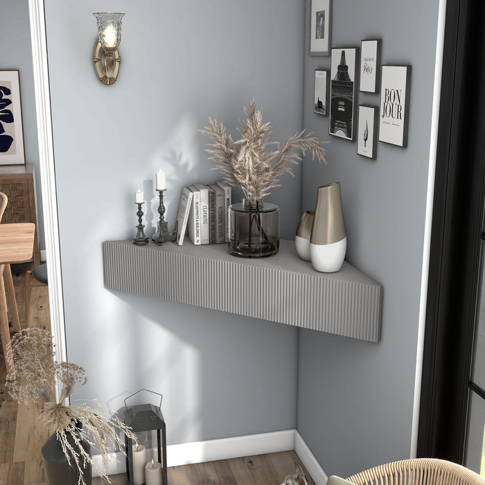 Left facing transitional grey wall-mount media console with a wavy front design in a room with accessories