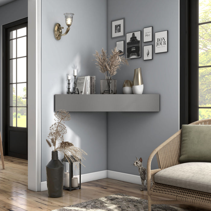 Front facing transitional grey wall-mount media console with a wavy front design in a room with accessories