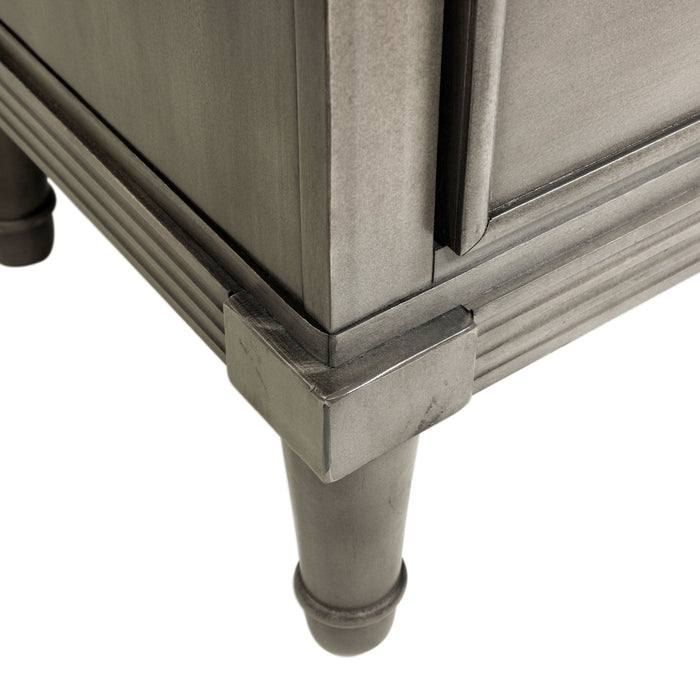 Detail shot of the tapered foot of a transitional grey 2-drawer nightstand.